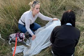 Laura keeping one of the children warm with Siobhan