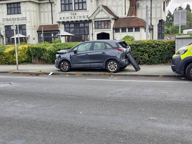 A damaged car on the pavement outside the Newbridge restaurant off the A41