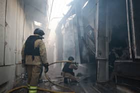 Rescue workers put out a fire of the central market damaged in a Russian strike on Zaporizhzhia, Ukraine