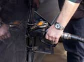 A person fills up a vehicle with diesel