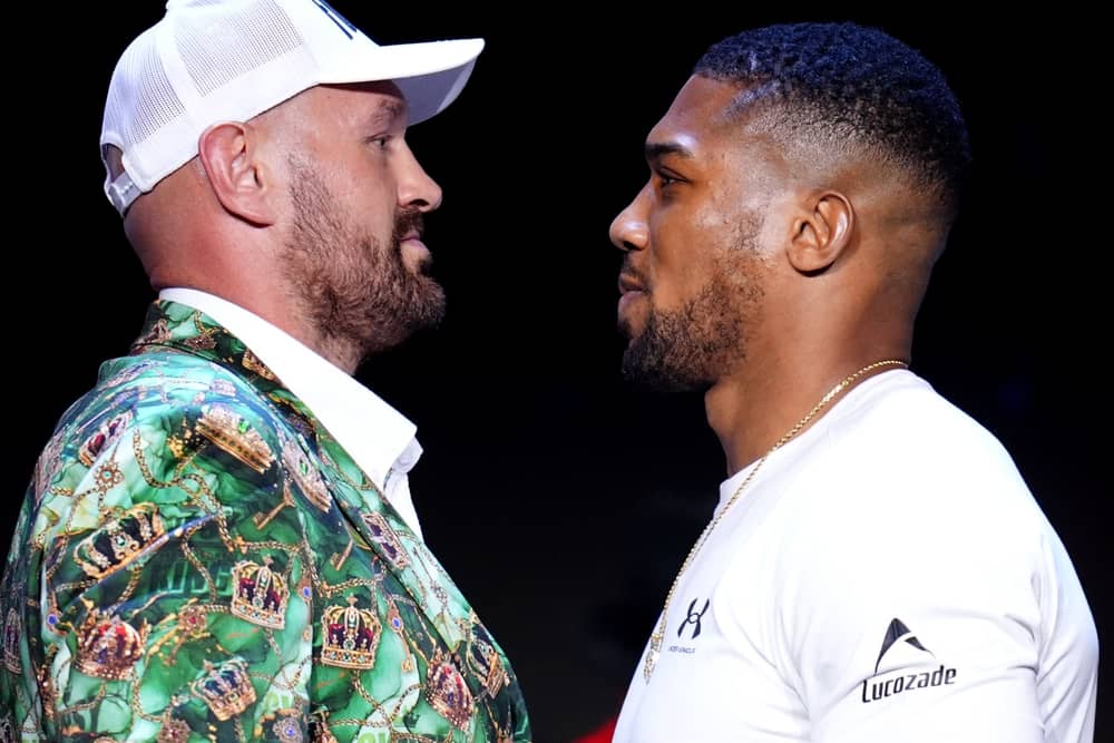 Anthony Joshua (right) will take on Tyson Fury in Cardiff in December