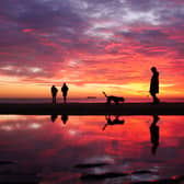 People on Cullercoats Beach, North Tyneside, at sunrise on September 27 2026