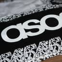 An Asos delivery package lying on the floor along with letters received in the post
