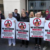 Demonstrators holding placards outside the Northern Ireland Office in Belfast