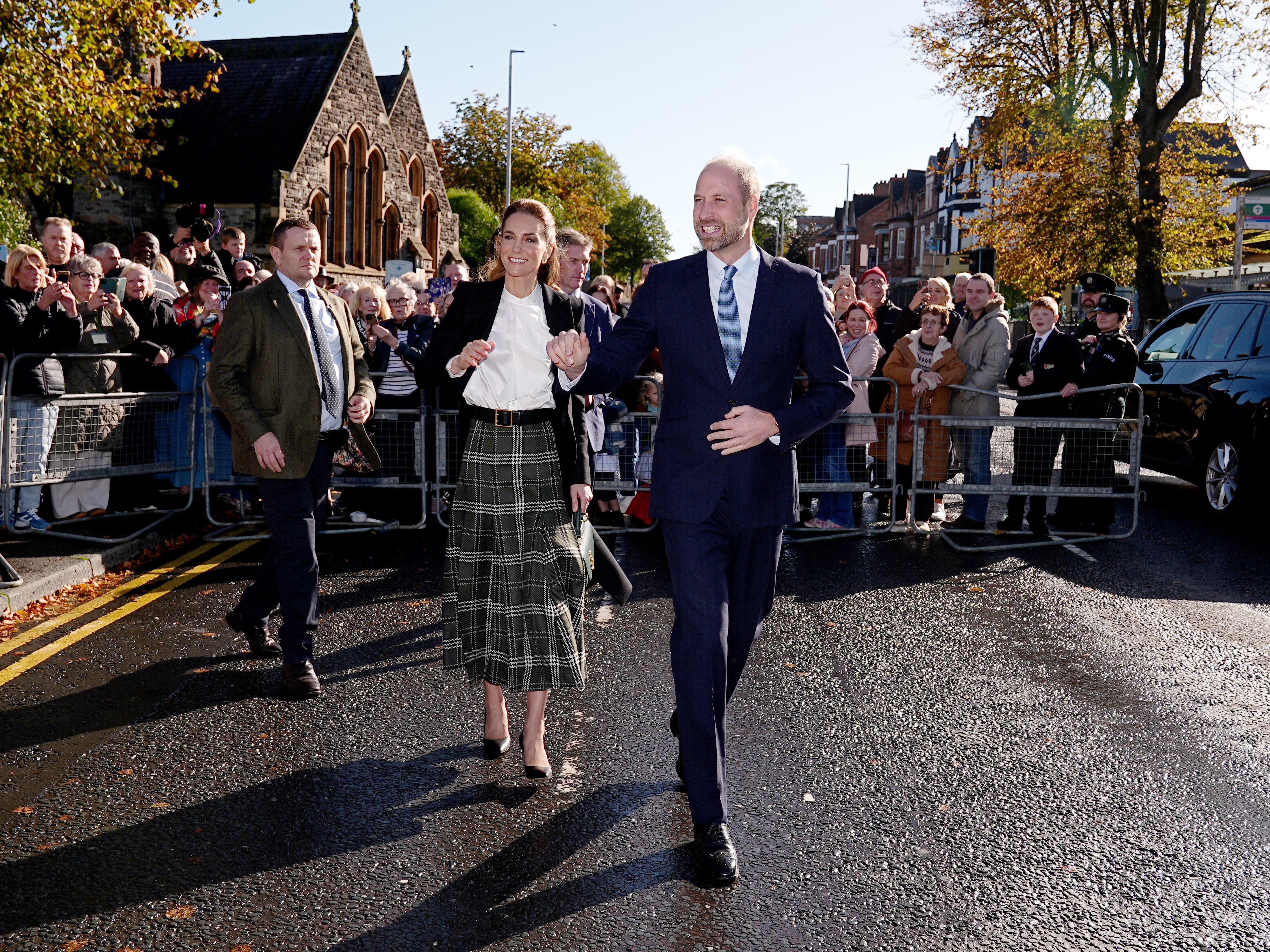 William and Kate dodge rain showers to meet community centre supporters