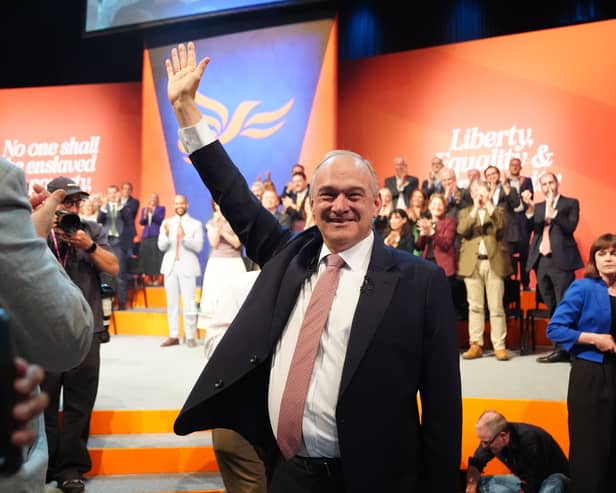 Ed Davey waves as he leaves the stage at the Lib Dem party conference