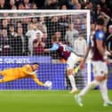 QPR goalkeeper Pierce Charles makes a save from a penalty kick
