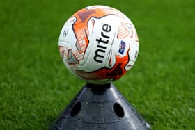 A football resting on a training cone