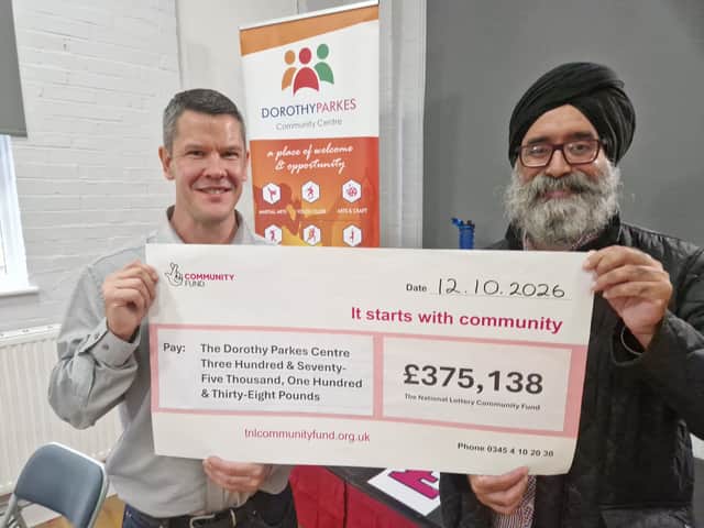 Robert Bruce, CEO of Dorothy Parkes Centre, receives funding cheque from Surinder Singh from the National Lottery