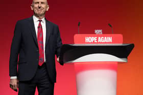 John Healey at the side of a lectern at the Labour Party conference