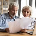 Old man and wife looking at energy bills
