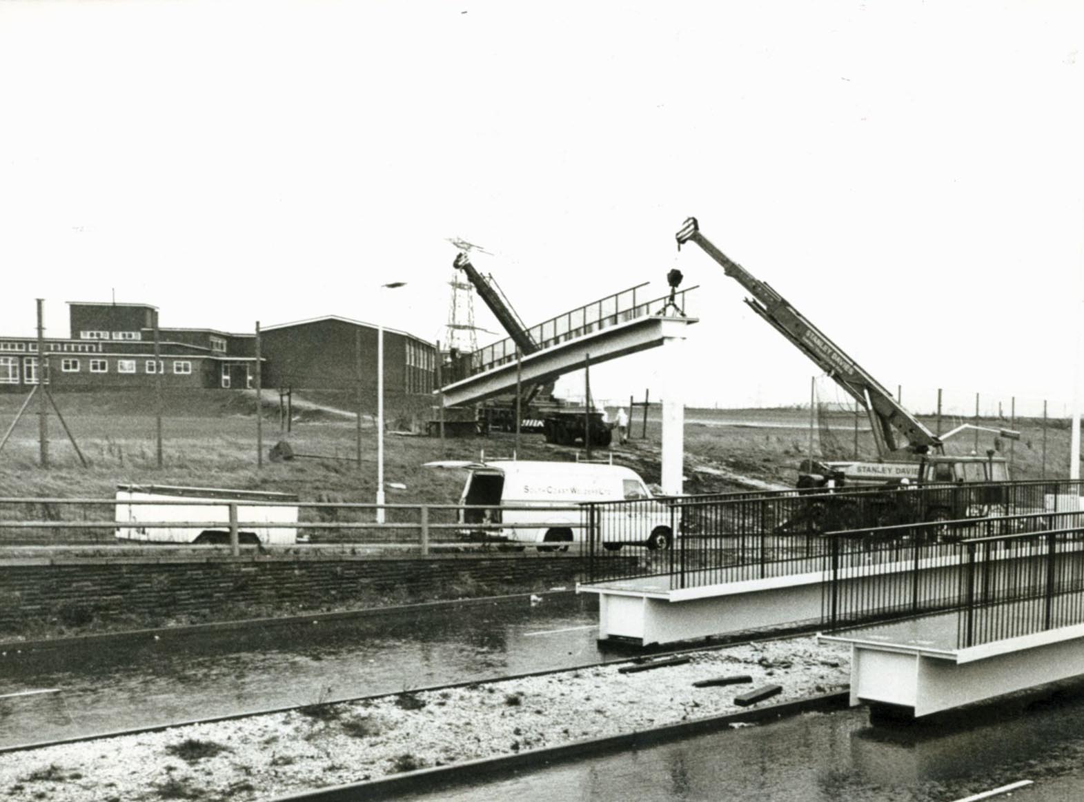 PICTURE FROM THE ARCHIVE: Cranes position a new footbridge section across Bilston Road, Willenhall, in January 1978. The elevated walkway was constructed to provide a safe crossing connecting the split campus sites of St Thomas More Comprehensive School. Did you attend St Thomas More Comprehensive back then, or do you remember when this footbridge was being built?