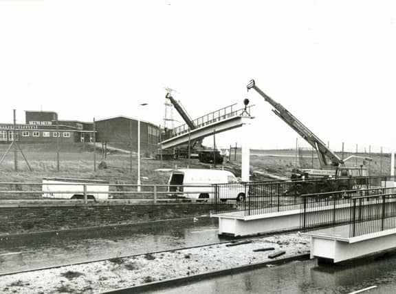 PICTURE FROM THE ARCHIVE: Cranes position a new footbridge section across Bilston Road, Willenhall, in January 1978. The elevated walkway was constructed to provide a safe crossing connecting the split campus sites of St Thomas More Comprehensive School. Did you attend St Thomas More Comprehensive back then, or do you remember when this footbridge was being built?
