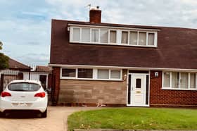Set back from a quiet residential road, the bungalow combines a lawned front garden with driveway parking for multiple vehicles and a detached garage