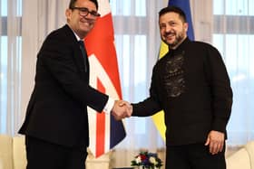 Volodymyr Zelensky shakes hands with Andy Burnham