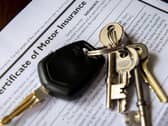 Car keys on a certificate of motor insurance.