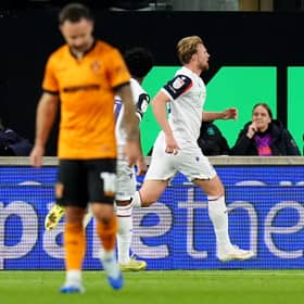 Dejected Wolves men Adam Armstrong (left) and Hugo Bueno (right) as Sam Dalby celebrates scoring for Bolton