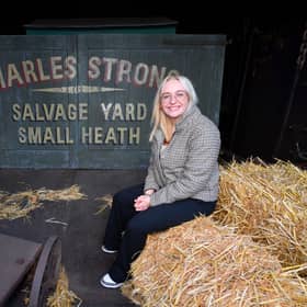 The new Peaky Blinders tour at Black Country Living Museum.
Reporter Emma Hynes sits next to the gates used in the Peaky Blinders series.
Tim Thursfield/Iconic Media Group

