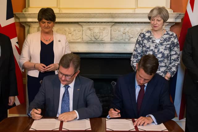 Donaldson signed the DUP confidence and supply arrangement with then PM Theresa May (Daniel Leal-Olivas/PA)