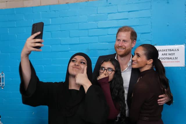 Harry and Meghan pose for a selfie at Epic Partners (Joe Giddens/PA)