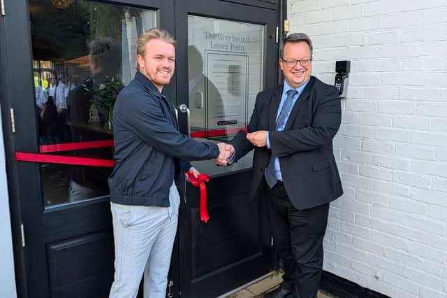 Matt Hogg and Mike Wood MP cut the ribbon to officially reopen the Greyhound. Photo: Dave Hughes