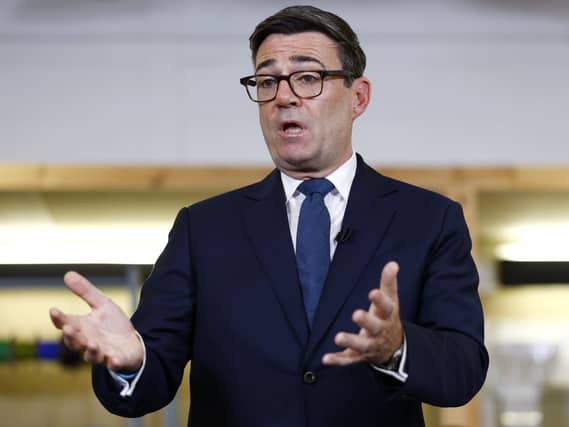 Andy Burnham gesturing as he delivers a speech