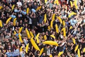 Manchester City fans hold up inflatable bananas at Anfield