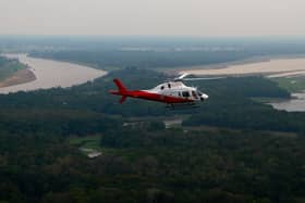 A helicopter from Brazil’s environmental agency flies over an area of the Amazon rainforest
