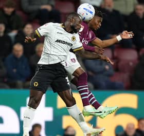 Wolves defender Ghislain Konan (left) battles with Burnley’s Largie Ramazani for the ball
