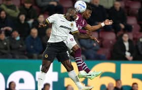 Wolves defender Ghislain Konan (left) battles with Burnley’s Largie Ramazani for the ball