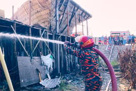 Firefighter sprays ruins