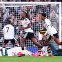 Alex Iwobi (left) celebrates scoring