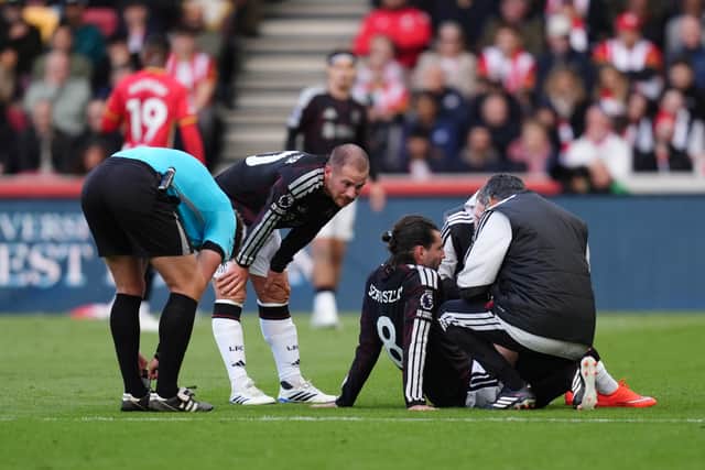 Liverpool’s Dominik Szoboszlai is treated on the pitch (John Walton/PA)