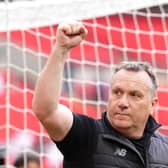 Oldham manager Micky Mellon raises a fist in celebration