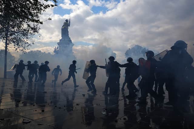 Police scuffle with protesters during a demonstration against rising living costs in Paris (Thibault Camus/AP)