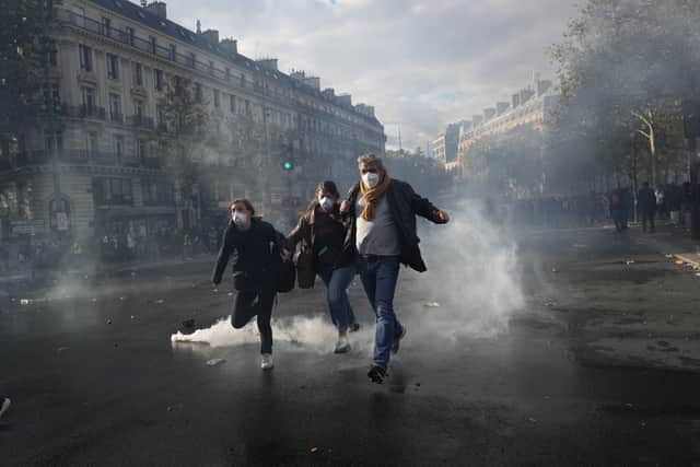 Protesters run to leave the Republique square during a demonstration in Paris (Thibault Camus/AP)