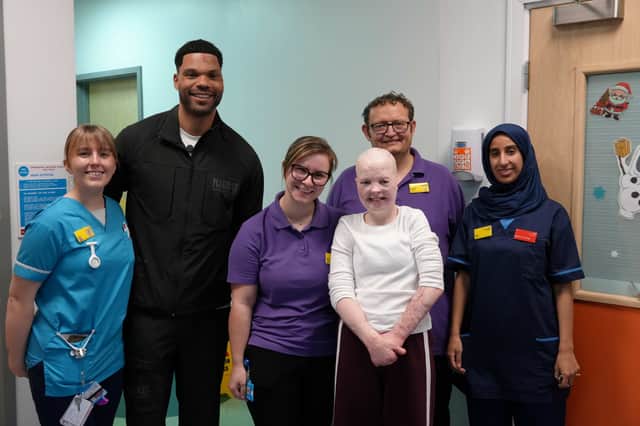 Joleon Lescott (second left) with patient Elizabeth Soffe (centre right, front)