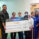 Joleon Lescott (far left) presenting £11,500 donation cheque, with patient Elizabeth Soffe (centre right, front) and Burns Centre clinical staff