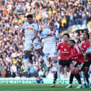 Leeds' James Justin (left) heads the ball clear from a corner