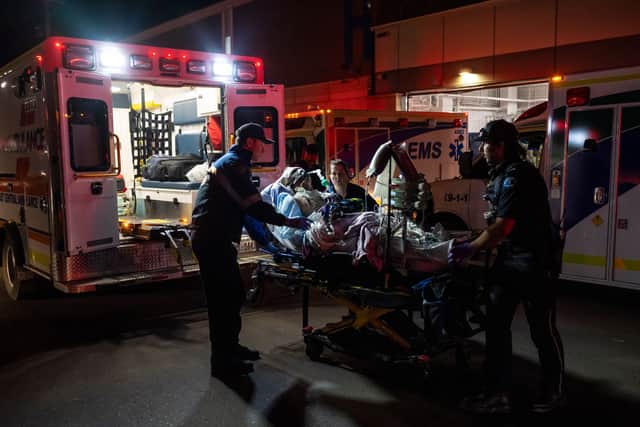 Paramedics load an injured person into an ambulance after the fire at Canadian Forces Base Wainwright (John Ulan/The Canadian Press/AP)