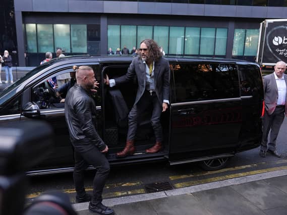 Russell Brand getting out of a car