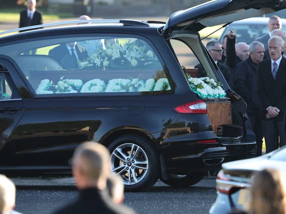 A hearse bearing the body of Paul Ferris