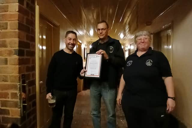 Shelly Bentley of Camra presents the award to Beacon Hotel owner Simon Massey, centre, with architect Andy Law, left