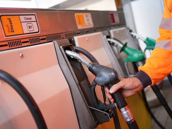 A person in hi-vis using a diesel pump