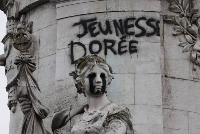 A tag reading ‘the golden youth’ on the statue of Equality at the Republique square in Paris (Christophe Ena/AP/PA)