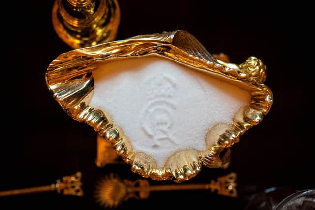The King Charles III cypher imprinted into salt on the banquet table in St George’s Hall (Aaron Chown/PA)