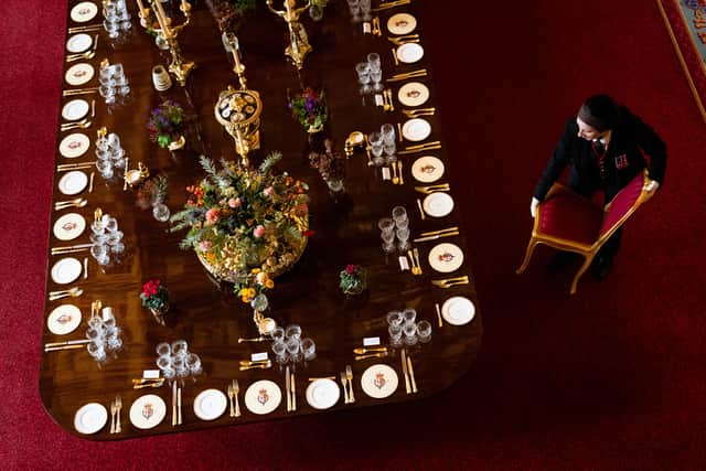 A chair is moved into position at the banquet table (Aaron Chown/PA)