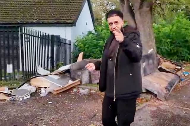 Councillor Harris Khaliq with the fly-tipped rubbish