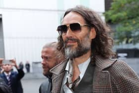 Russell Brand arrives at court in sunglasses