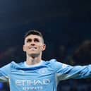 Manchester City’s Phil Foden stretches out his arms as he celebrates scoring against AEK Athens